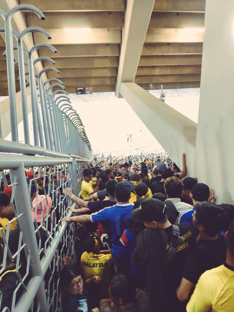 A group of supporters in an ocean of humans.