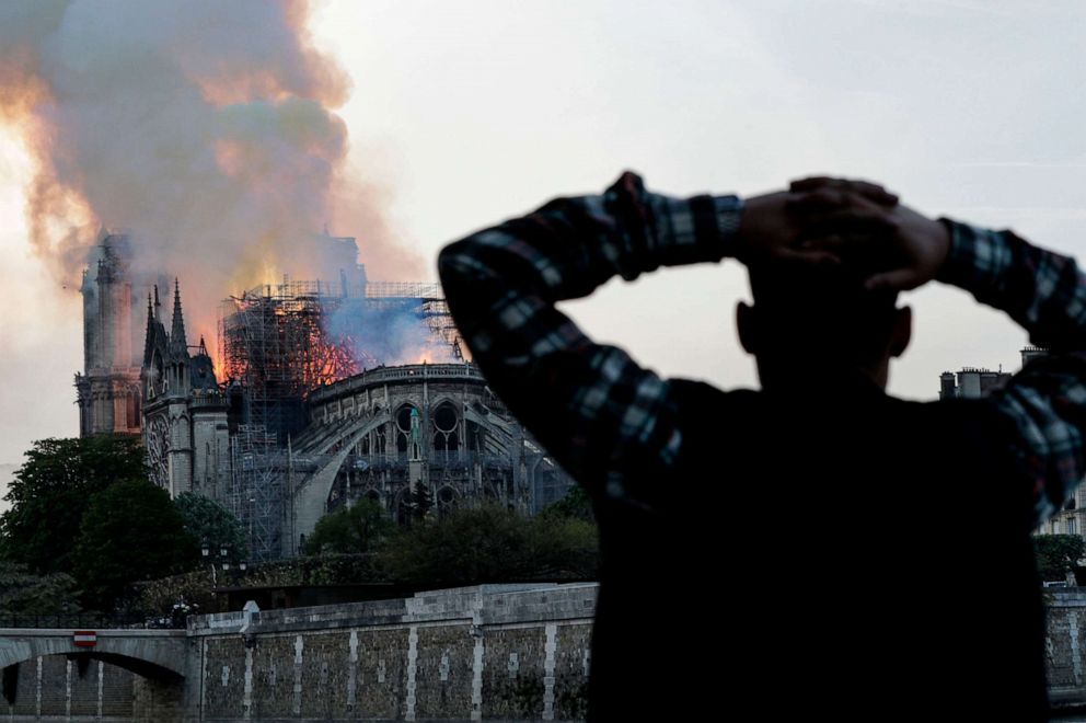 Distraught Parisians look on.