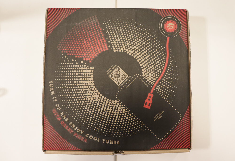 The design resembles a vinyl record player.