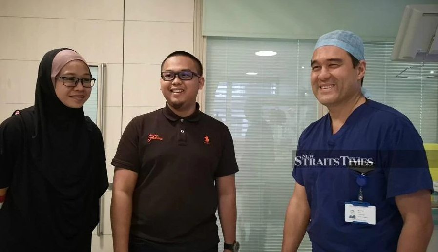 Juling Ong with Ainul's parents.