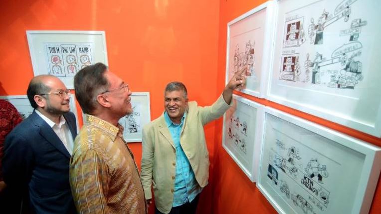 The Sun Daily Zunar showing off his work.