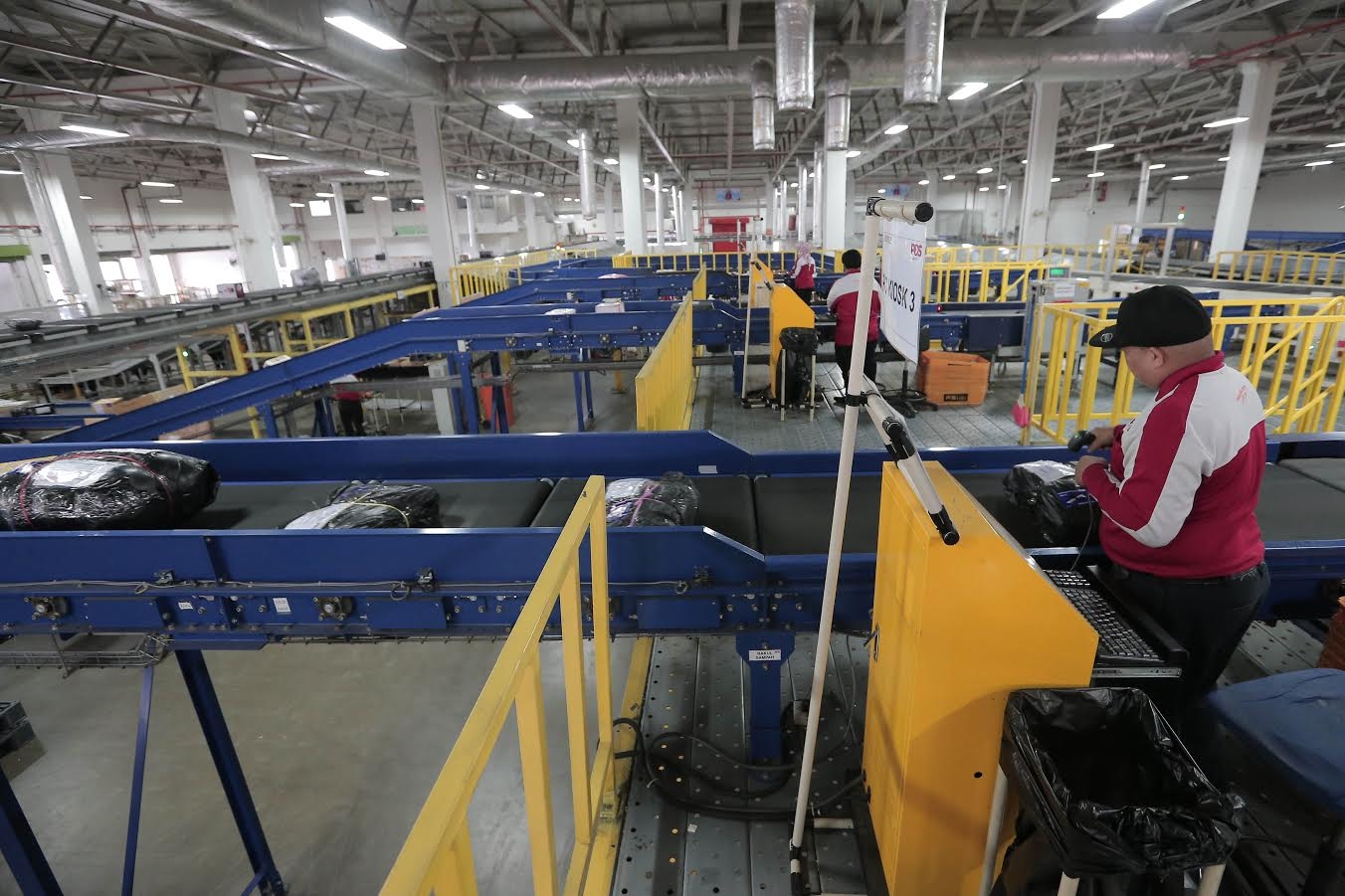 The Malay Mail Online Hardworking workers processing your stuff.