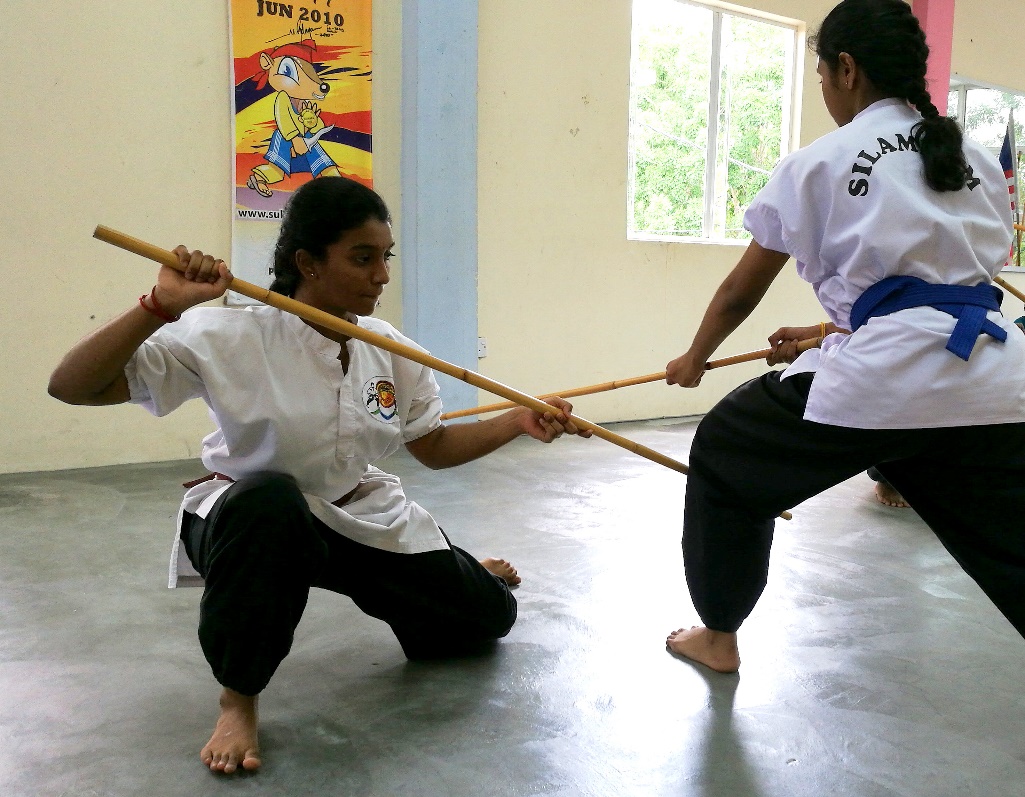Fighting with sticks.