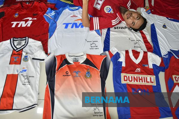 Isnain showing off his most treasured jerseys.