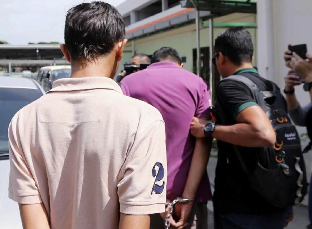 Suspects being led away by the police