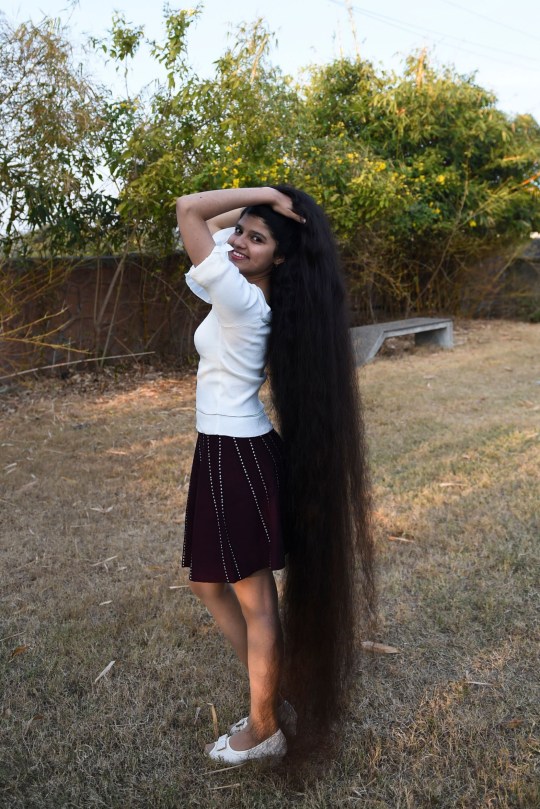 Her hair is longer than she is tall.