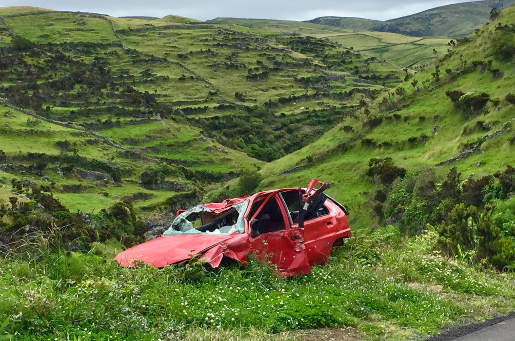 photo-of-broken-red-car-on-grass-3368844.jpg
