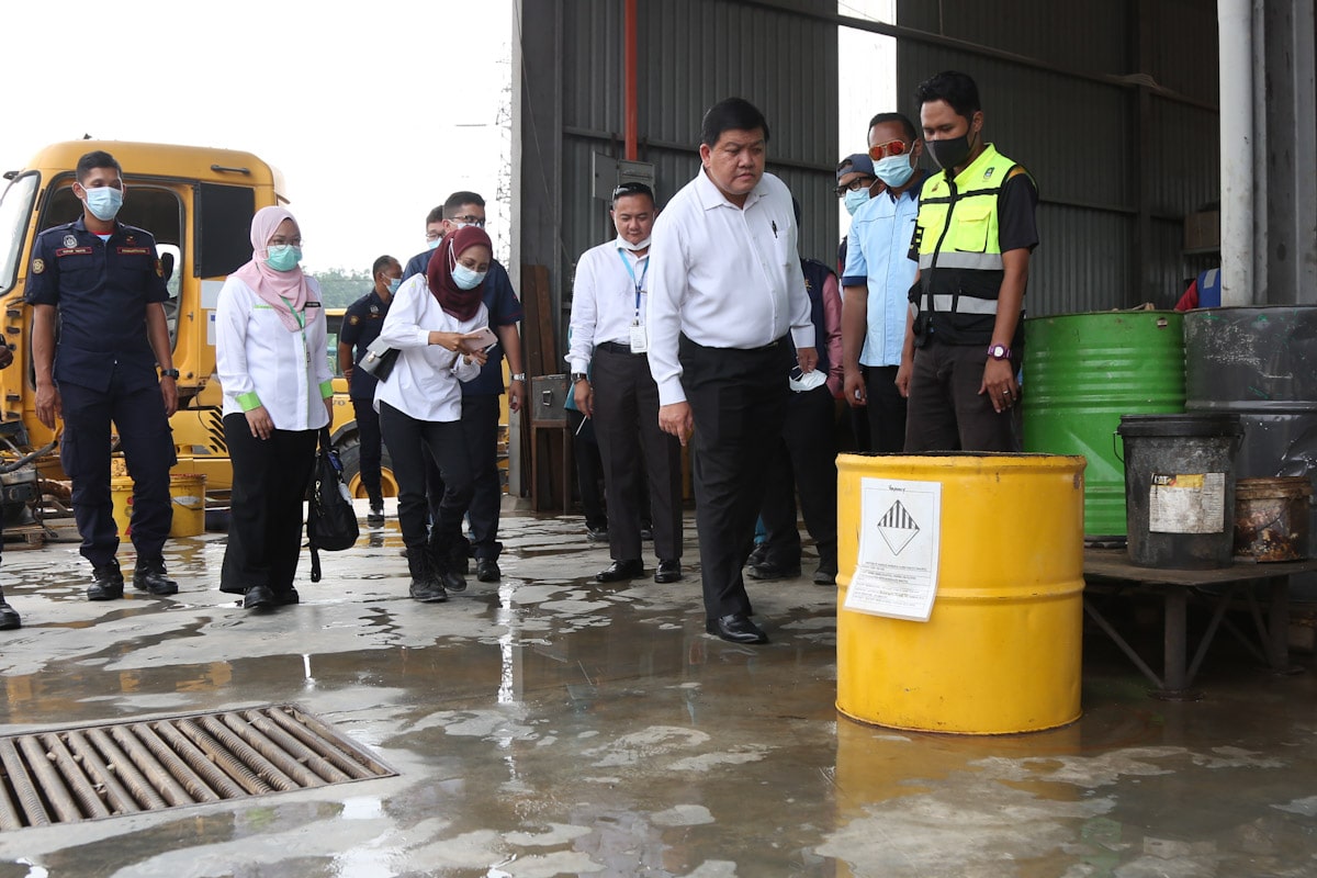 Authorities inspecting a heavy machinery maintenance plant in Rawang.