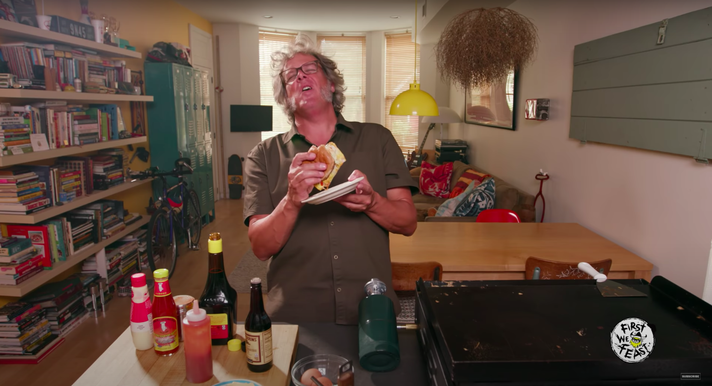Look at how much he enjoys the burger.