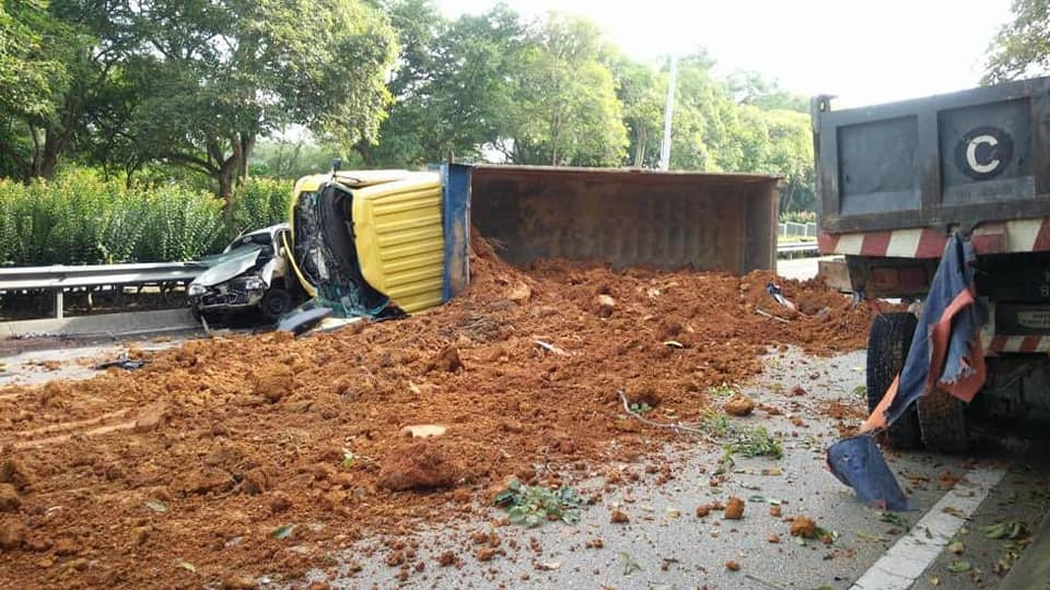 The road was blocked by a rolled-over truck.