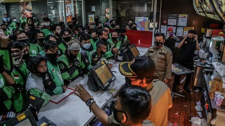 Dozens of delivery riders raided McDonald's.