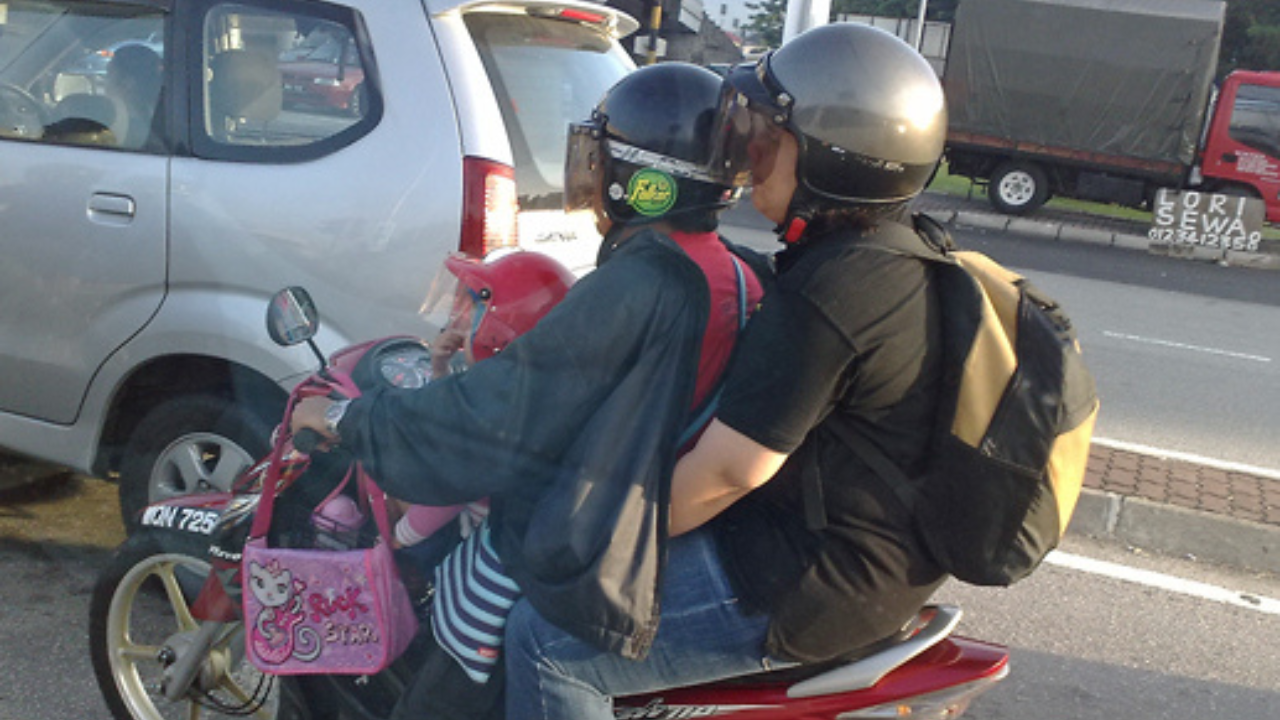 motorcyclist wearing jacket backwards